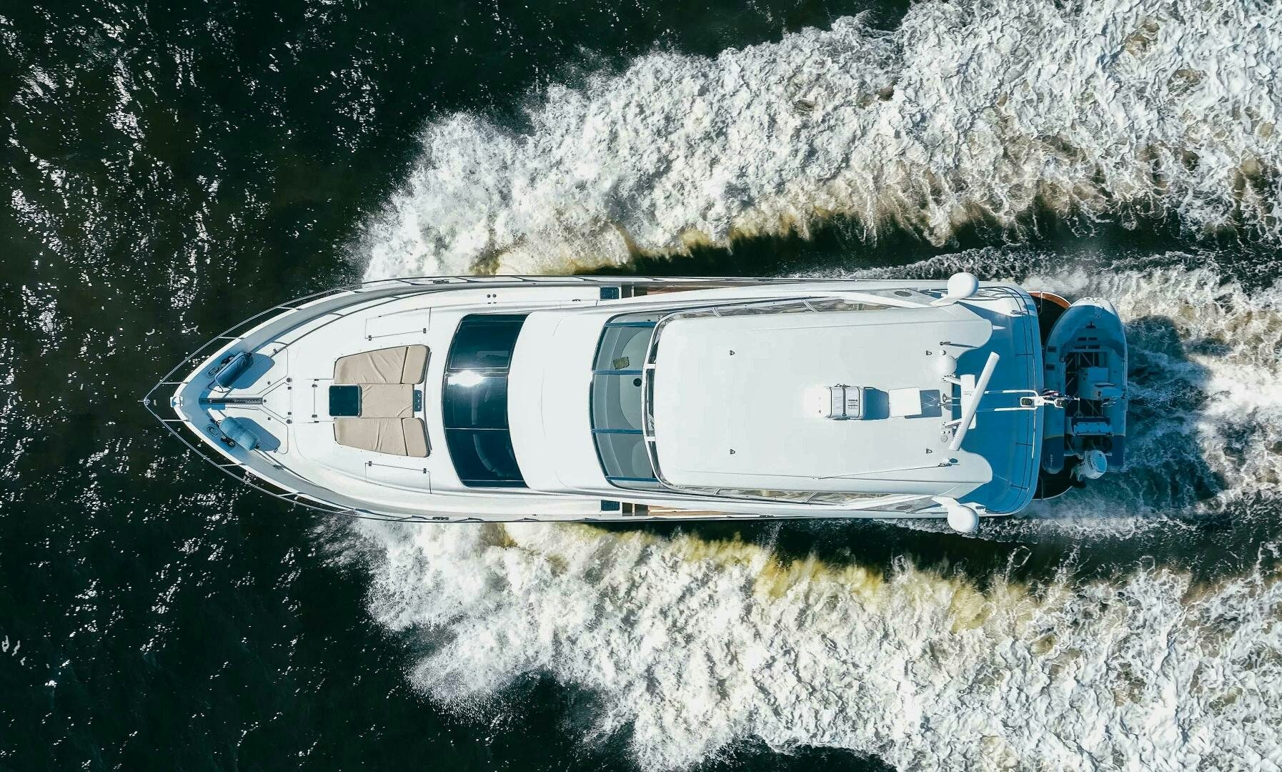 a helicopter flying over a mountain aboard SERENITY Yacht for Sale