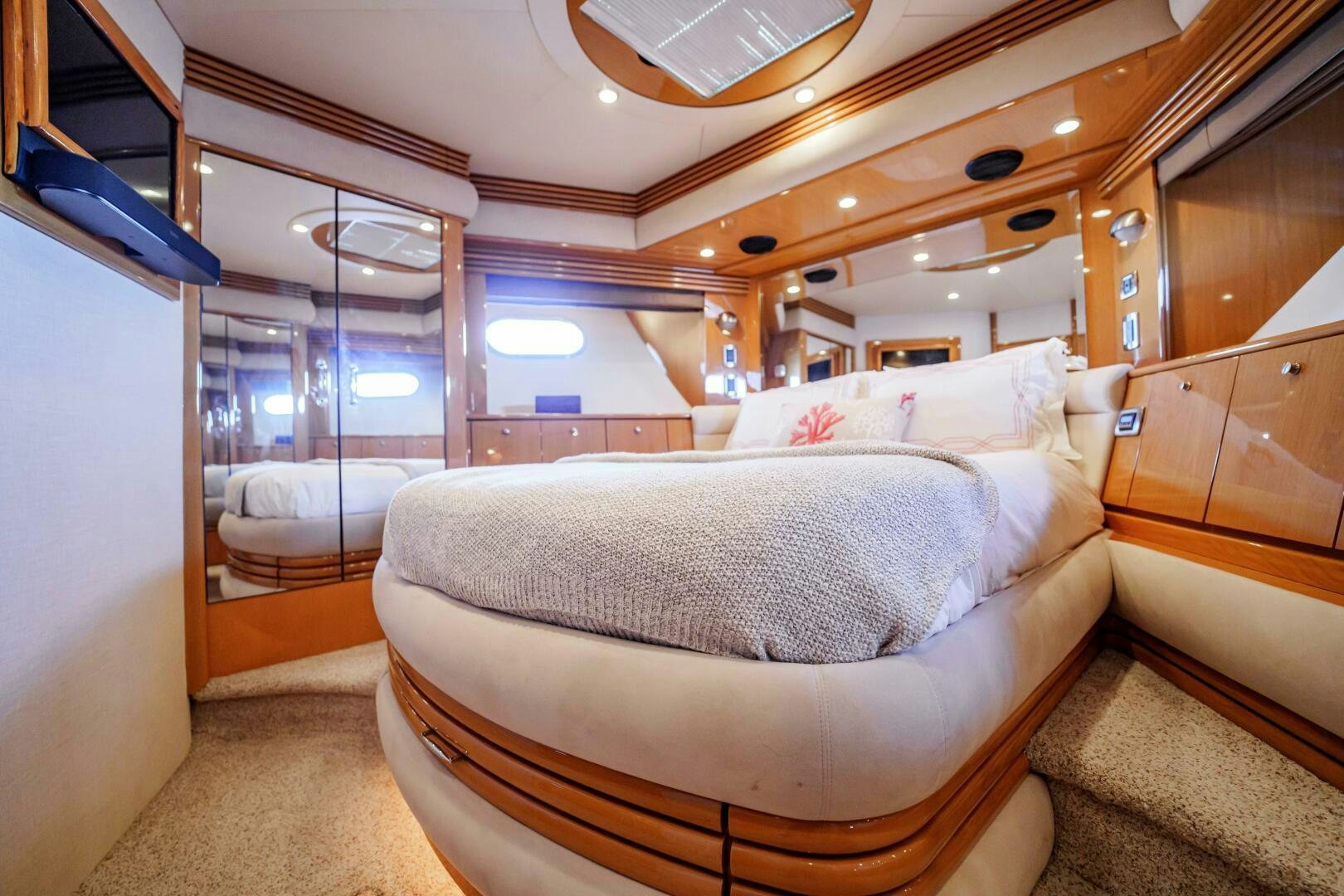 a room with a bed and a mirror aboard SERENITY Yacht for Sale