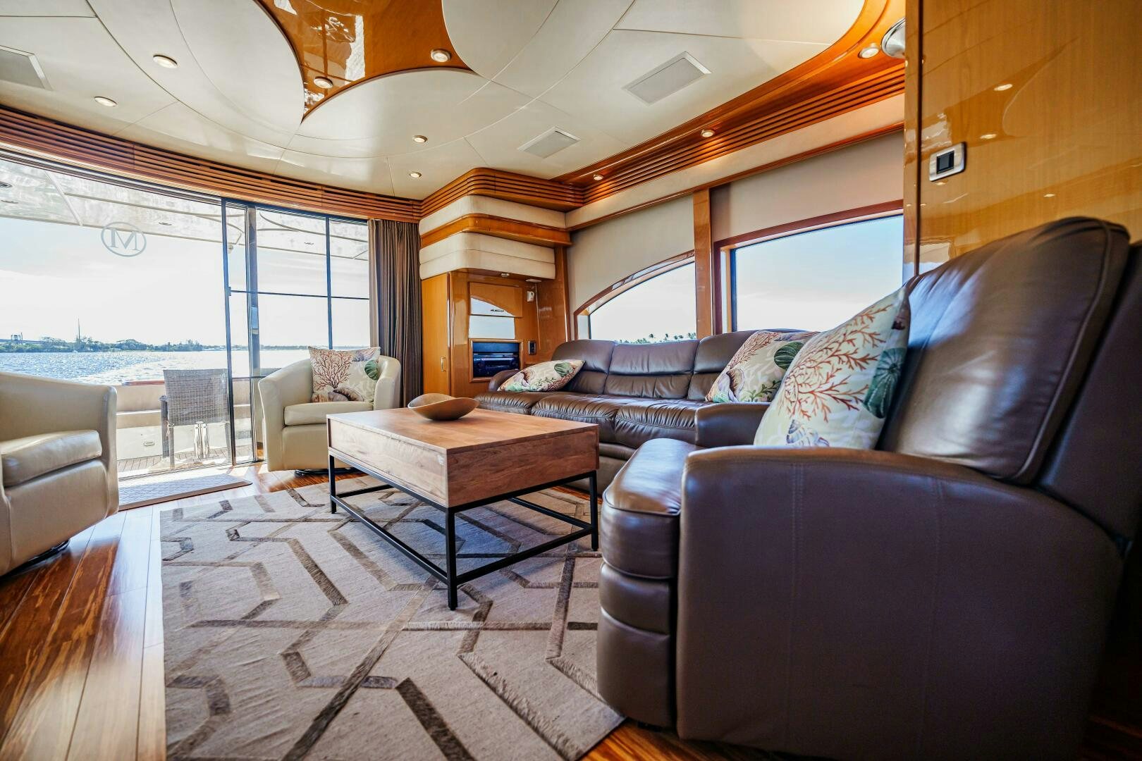 a living room with leather couches aboard SERENITY Yacht for Sale