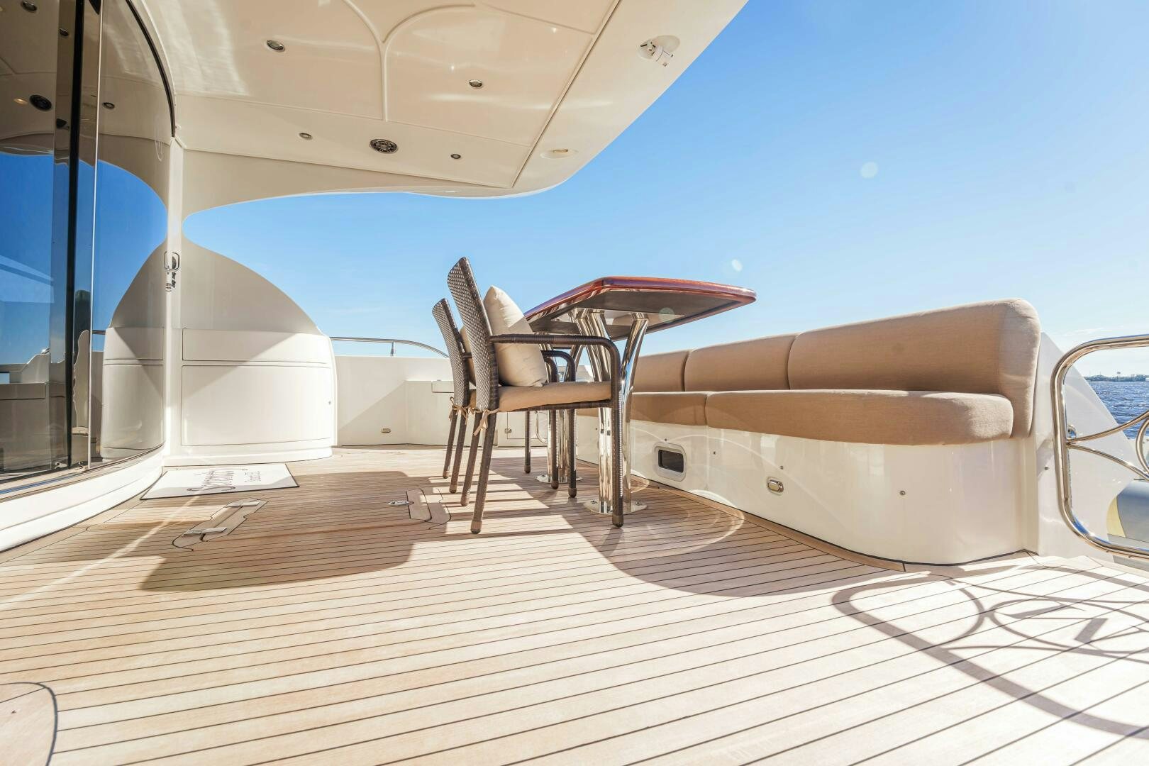 a chair and a table on a deck aboard SERENITY Yacht for Sale
