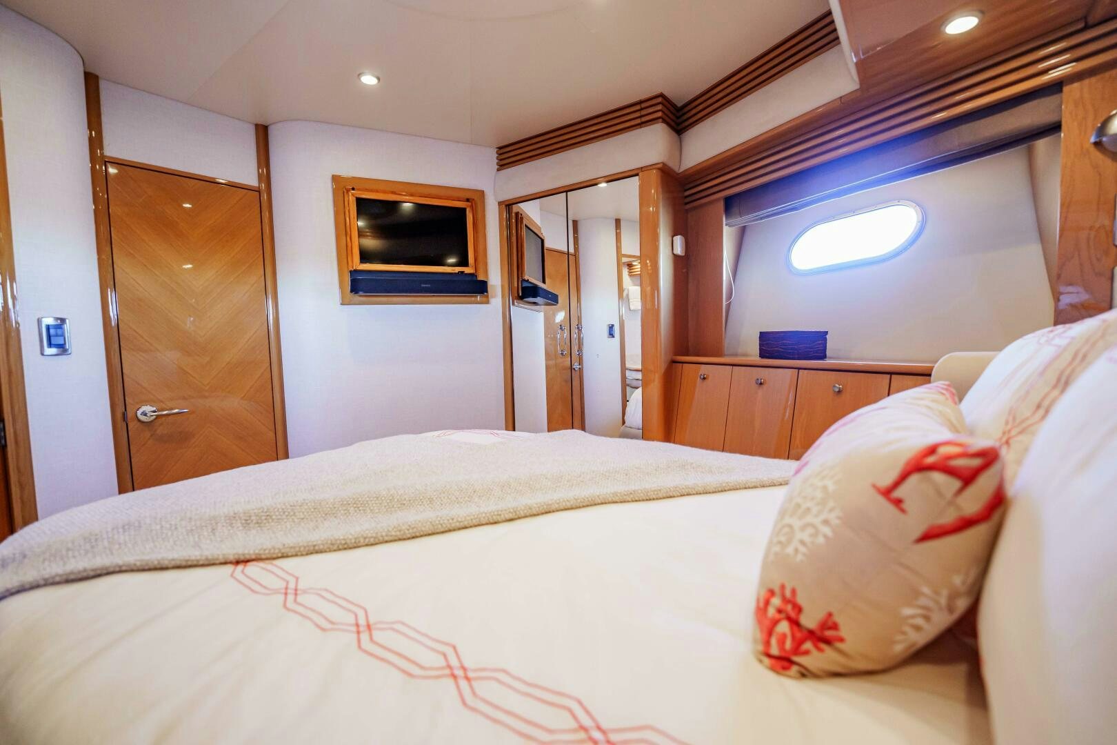 a bedroom with a bed and a television on the wall aboard SERENITY Yacht for Sale