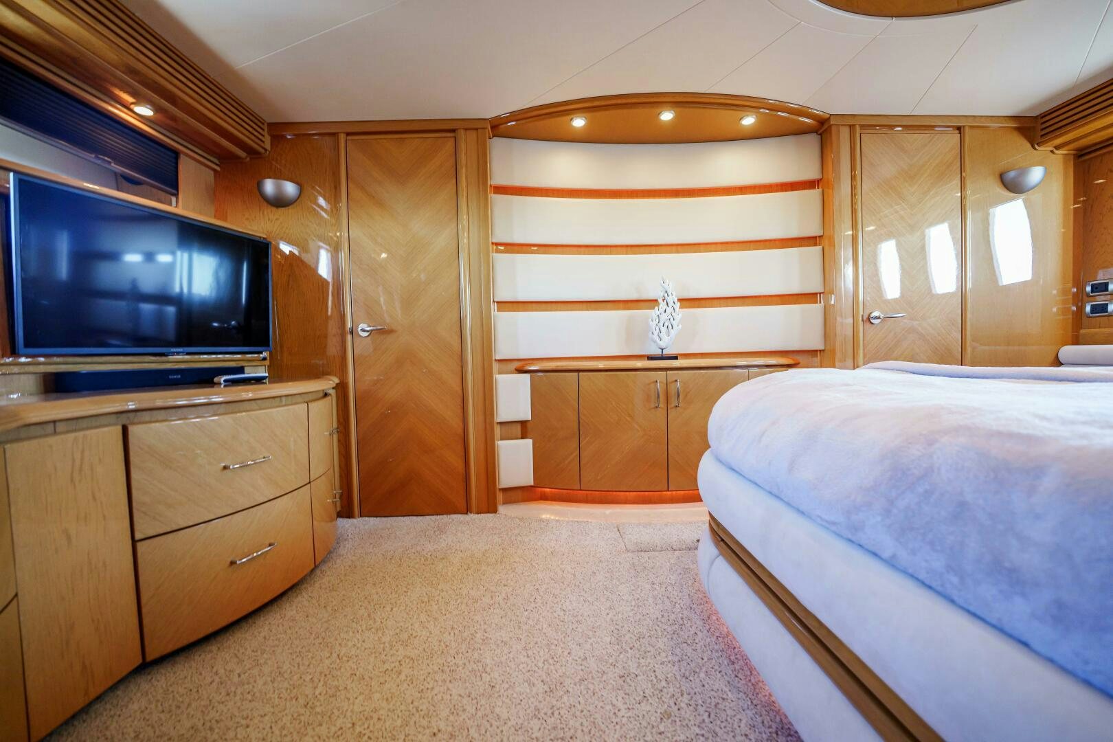 a bedroom with a bed and a television aboard SERENITY Yacht for Sale
