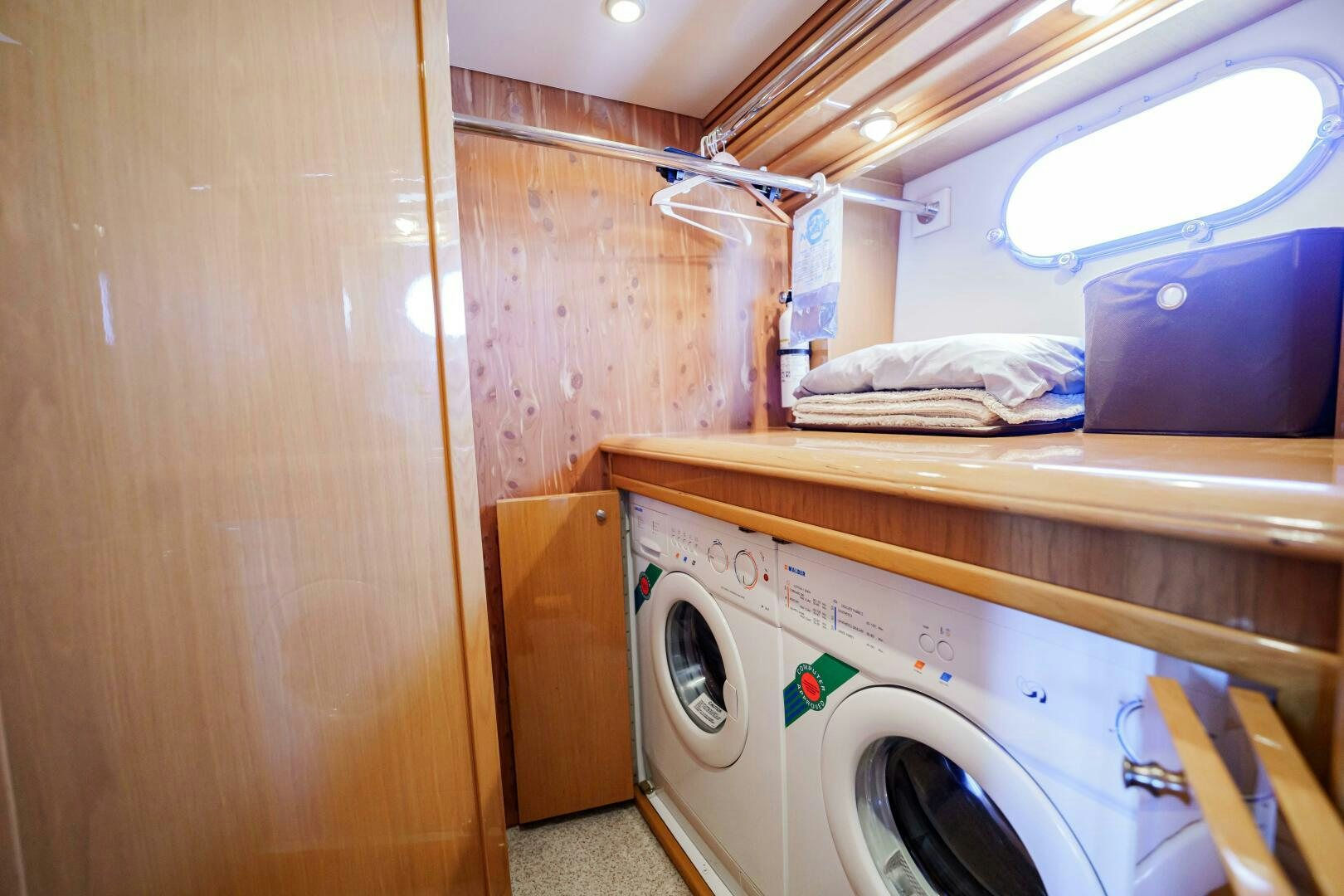 a small laundry room with a washing machine aboard SERENITY Yacht for Sale