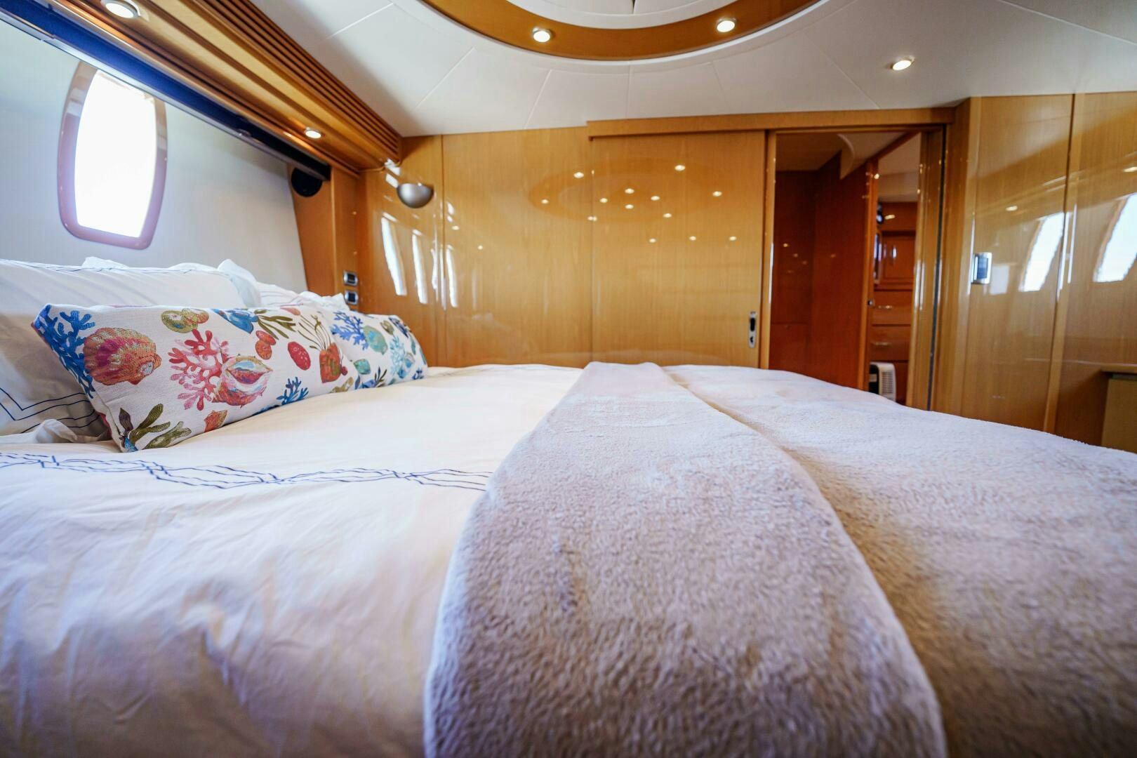 a bed with a pink comforter aboard SERENITY Yacht for Sale