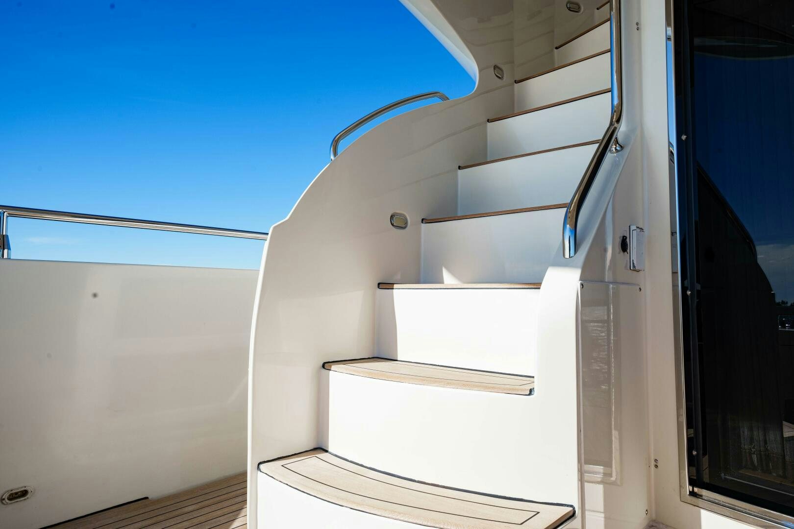 a white staircase with a metal railing aboard SERENITY Yacht for Sale