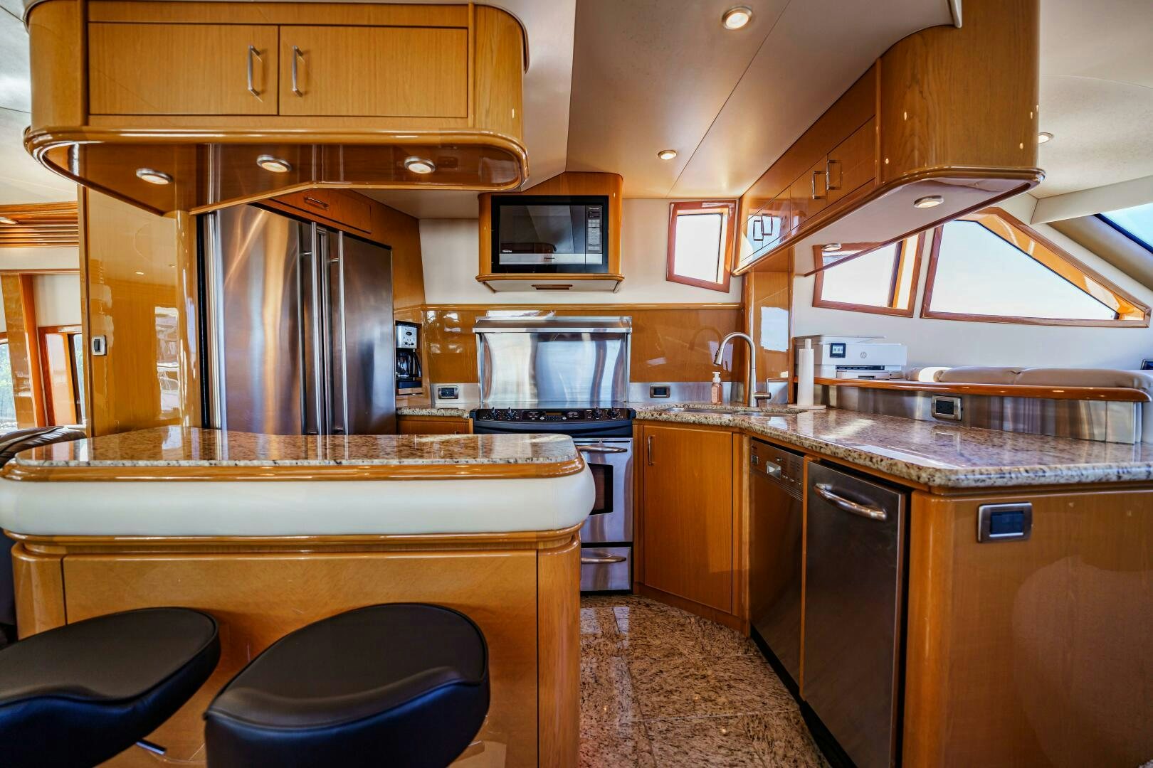 a kitchen with wooden cabinets aboard SERENITY Yacht for Sale