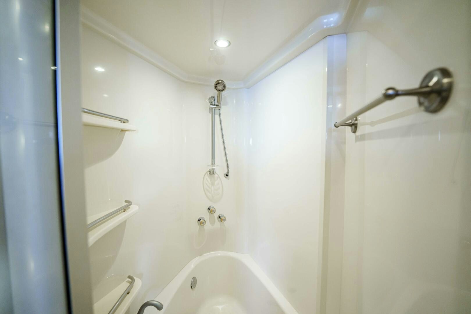 a bathroom with a bathtub and shower aboard SERENITY Yacht for Sale
