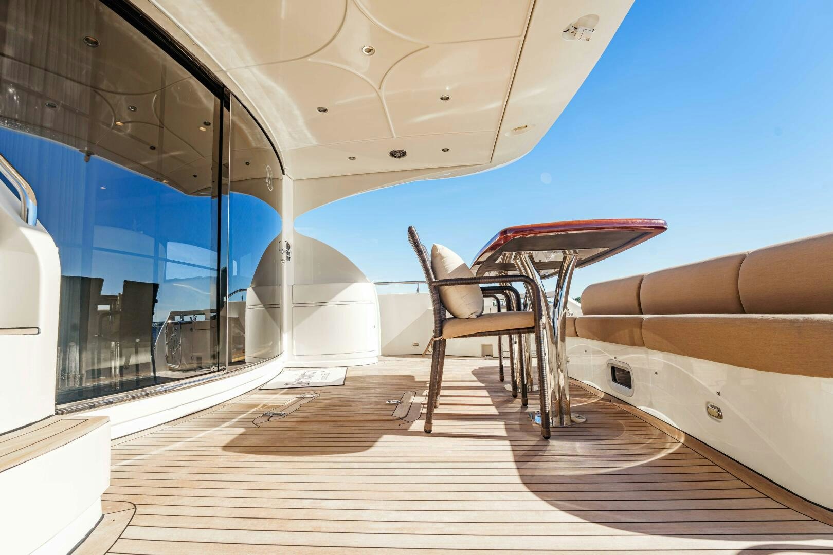 a chair and a desk in a room with windows aboard SERENITY Yacht for Sale