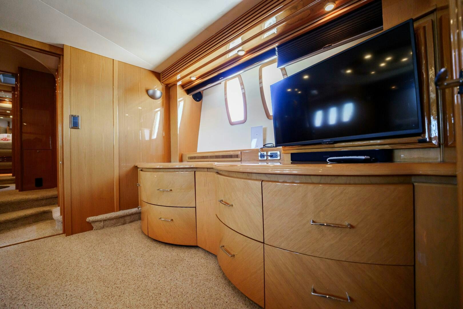 a room with a tv and dresser aboard SERENITY Yacht for Sale