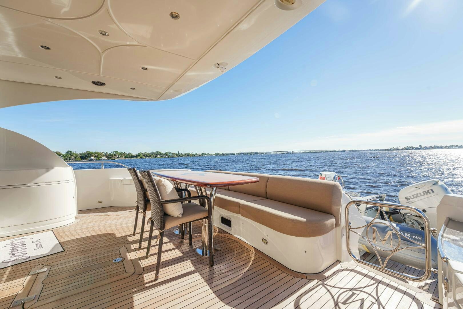 a deck with a table and chairs on it aboard SERENITY Yacht for Sale