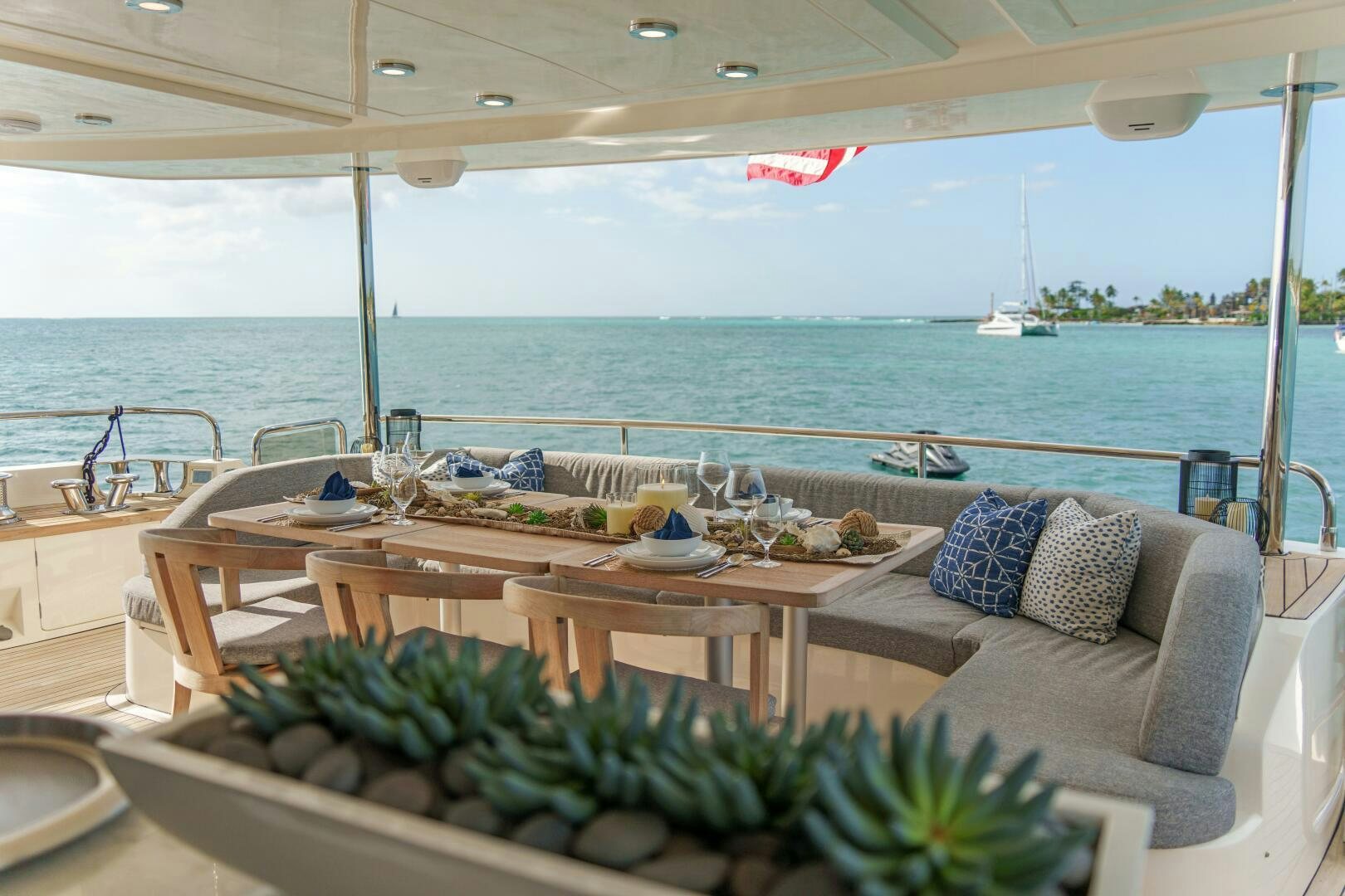 a table with plants on it by a large body of water aboard CURRENT SEA Yacht for Sale