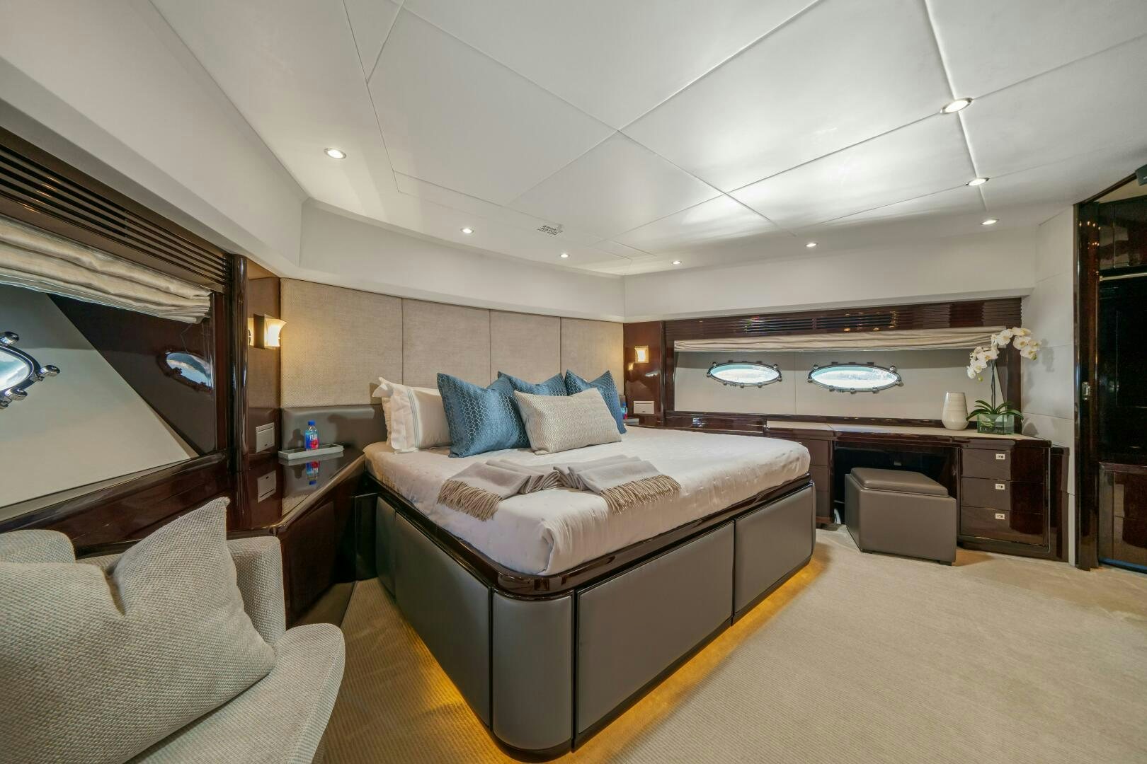 a bedroom with a bed and a couch aboard CURRENT SEA Yacht for Sale