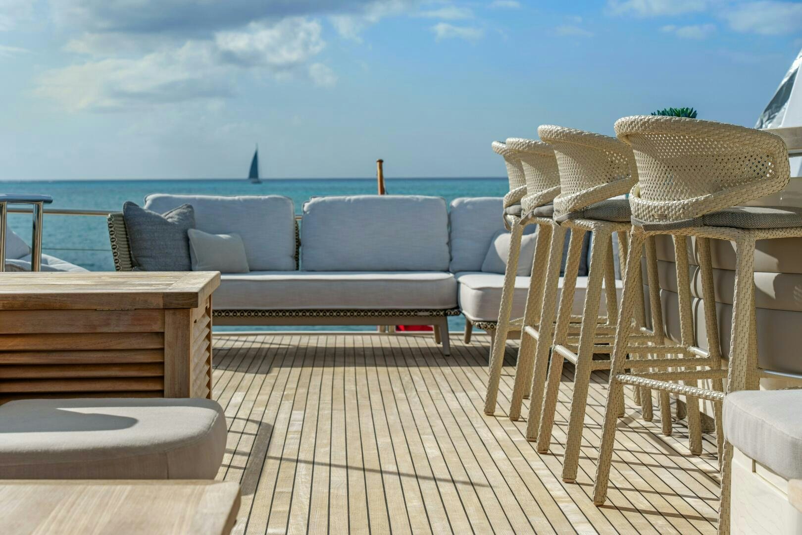 a deck with chairs and a table on it aboard CURRENT SEA Yacht for Sale