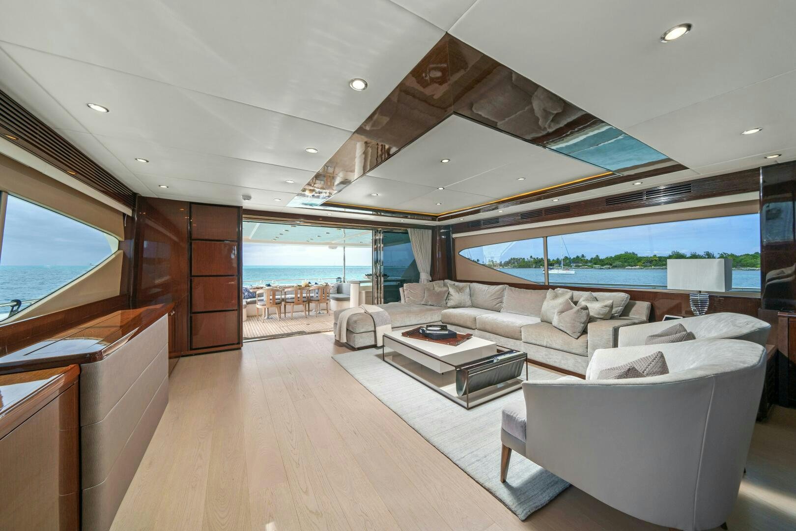 a living room with a large open window aboard CURRENT SEA Yacht for Sale