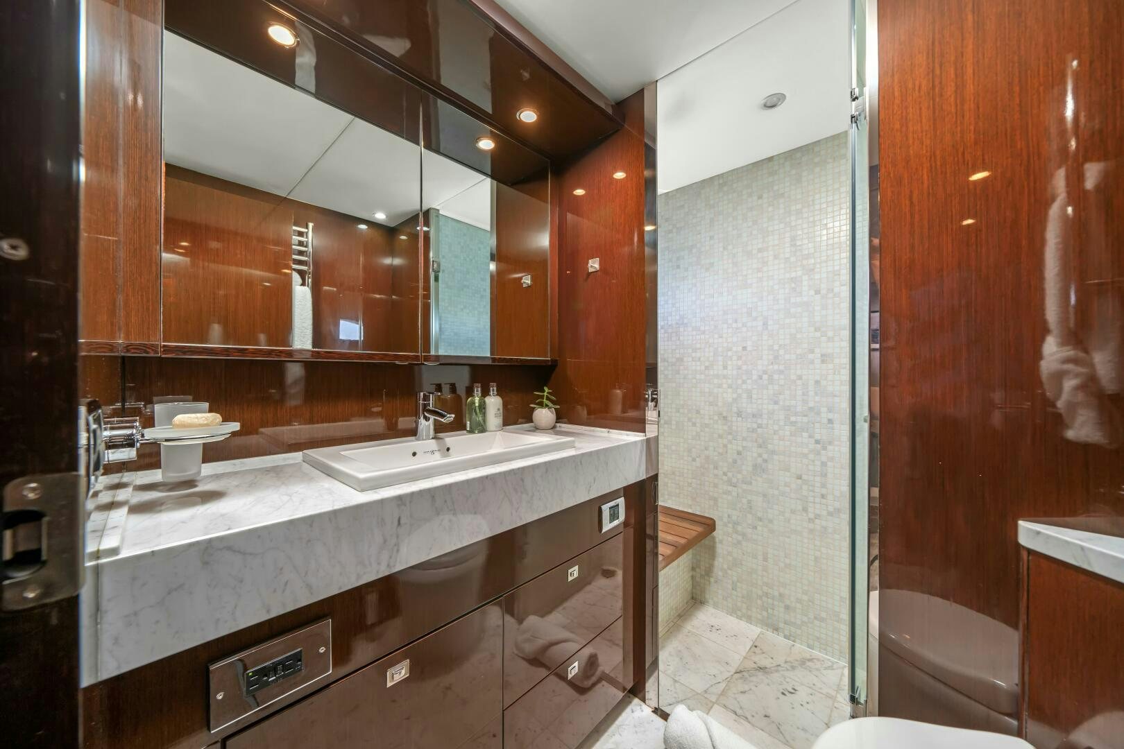a bathroom with a large mirror aboard CURRENT SEA Yacht for Sale
