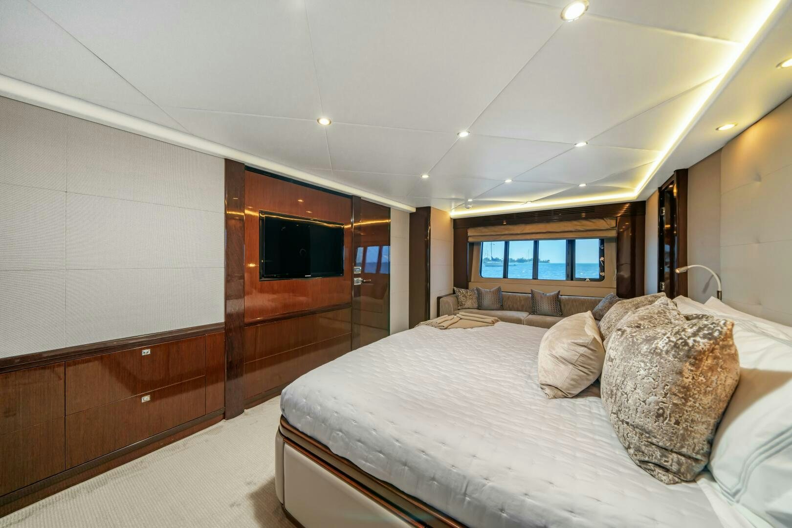 a bedroom with a bed and a wood door aboard CURRENT SEA Yacht for Sale