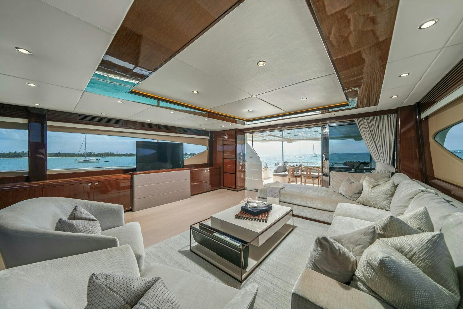 a living room with a large glass window aboard CURRENT SEA Yacht for Sale