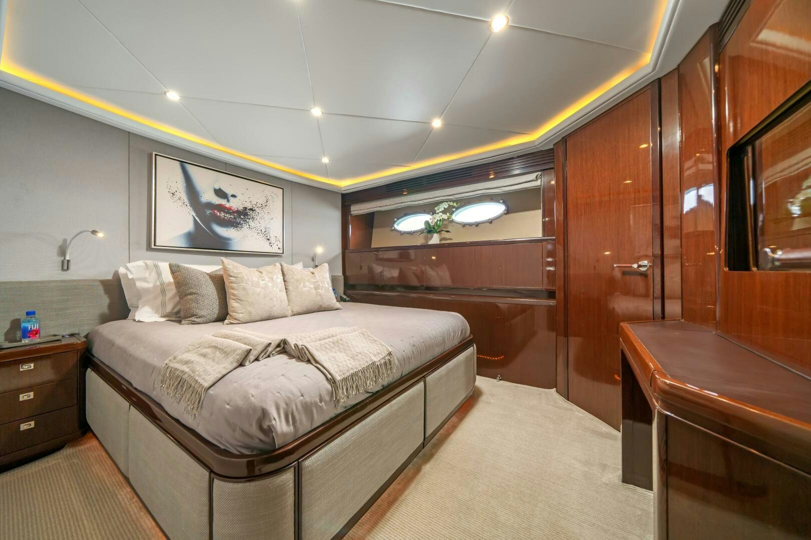 a bedroom with a bed and a dresser aboard CURRENT SEA Yacht for Sale
