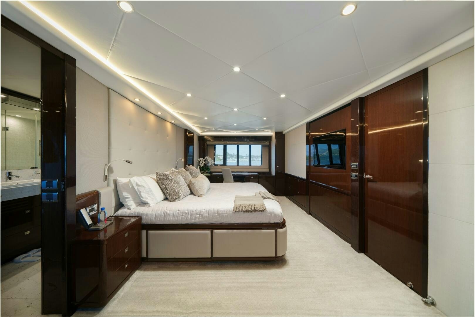 a bedroom with a bed and a desk aboard CURRENT SEA Yacht for Sale