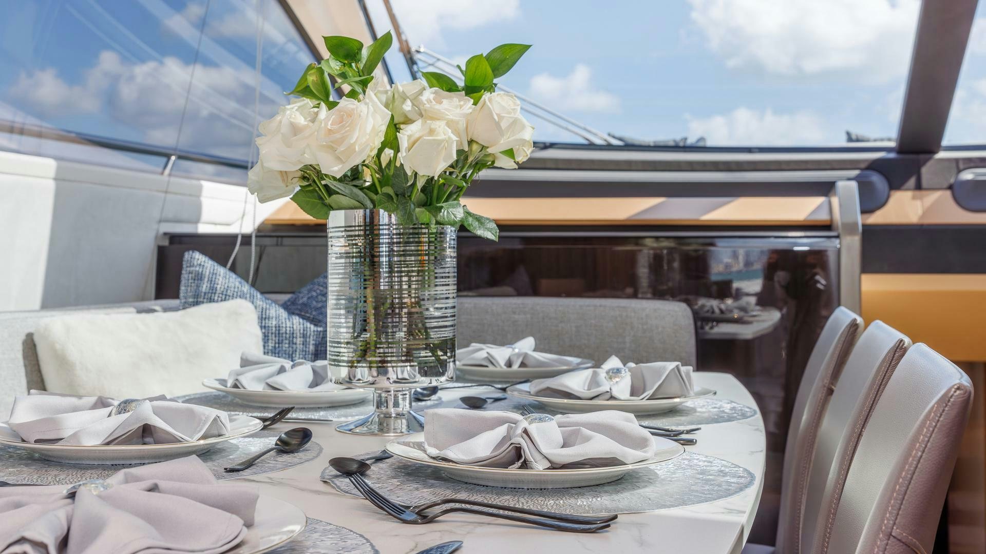 a vase of flowers on a table aboard DEVENZO Yacht for Sale