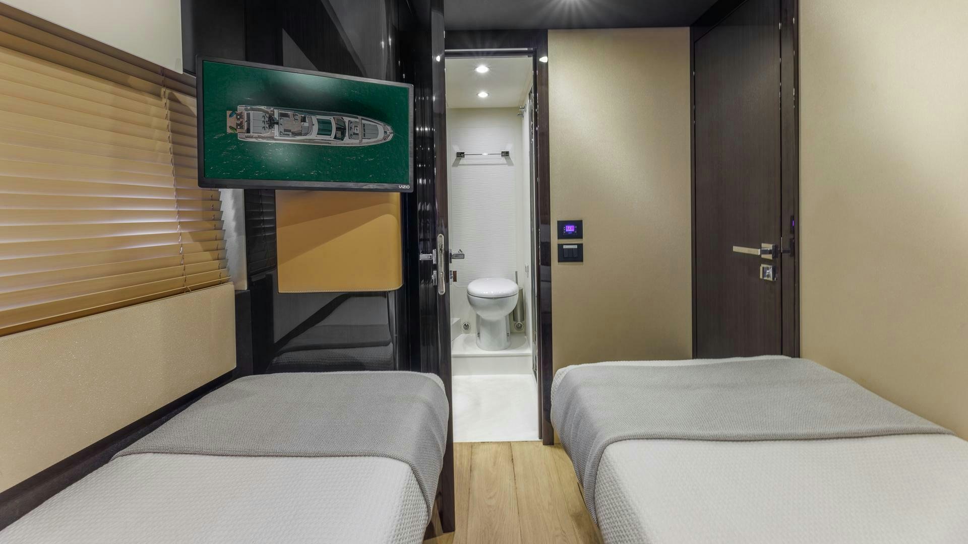 a room with a bed and a door aboard DEVENZO Yacht for Sale