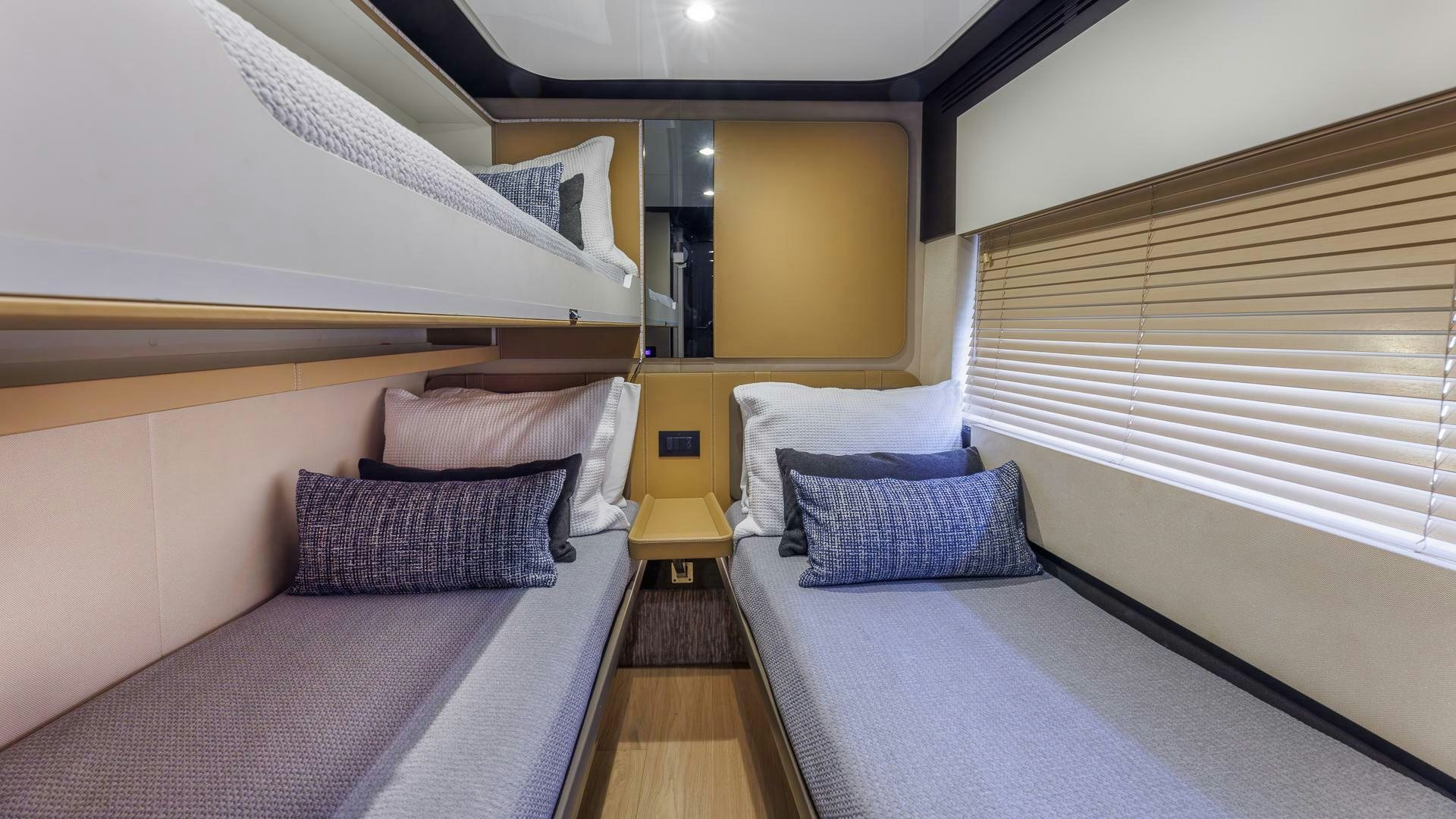 a room with beds and a wood floor aboard DEVENZO Yacht for Sale
