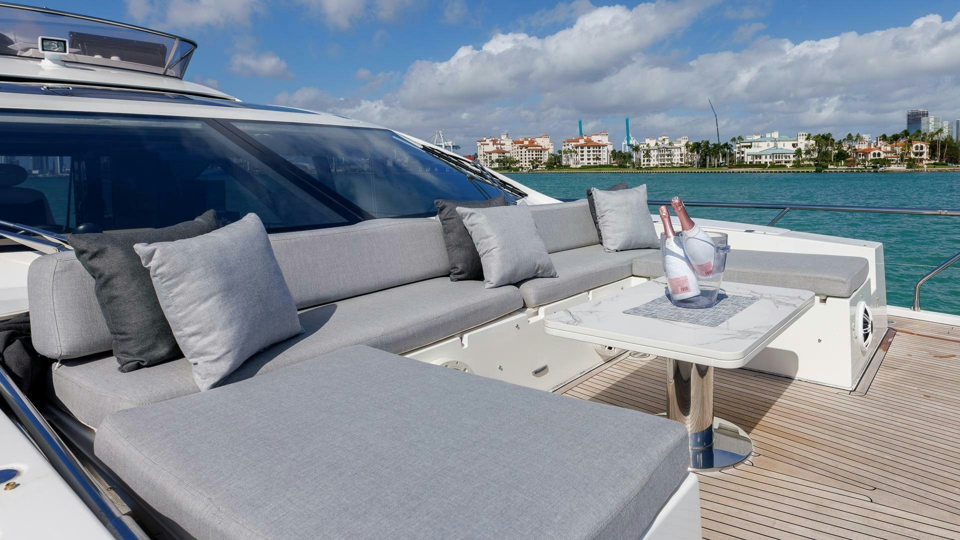 a couch with a table on it aboard DEVENZO Yacht for Sale