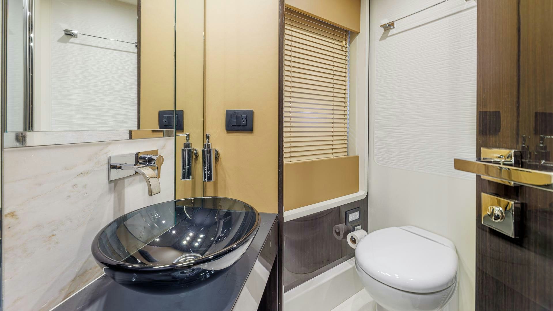 a bathroom with a sink toilet and bathtub aboard DEVENZO Yacht for Sale