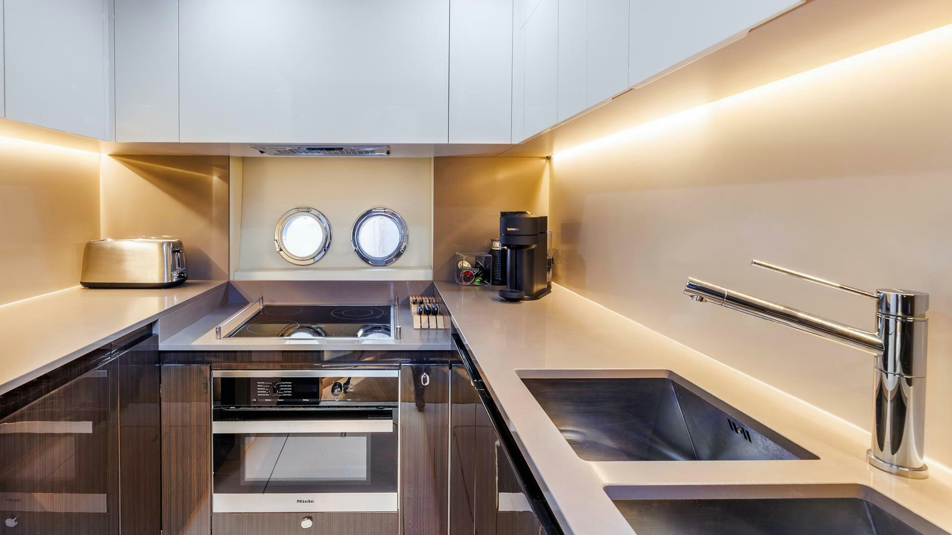 a kitchen with a sink and a microwave aboard DEVENZO Yacht for Sale