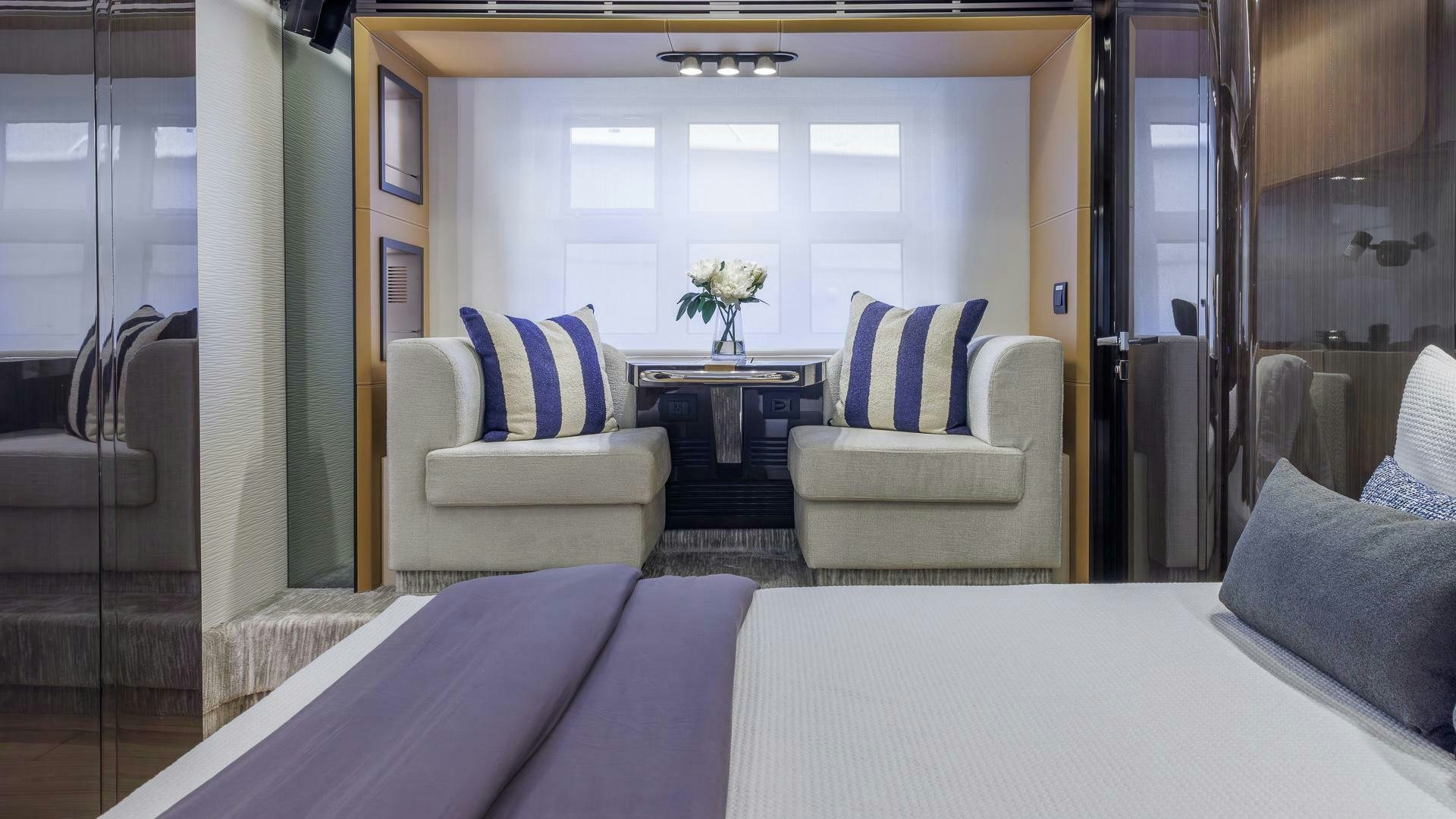 a room with a bed and a table aboard DEVENZO Yacht for Sale