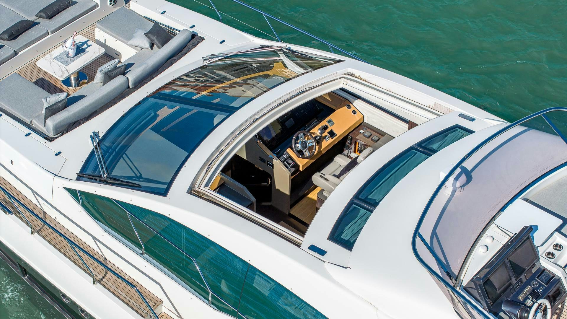 a boat with a yellow car on it aboard DEVENZO Yacht for Sale