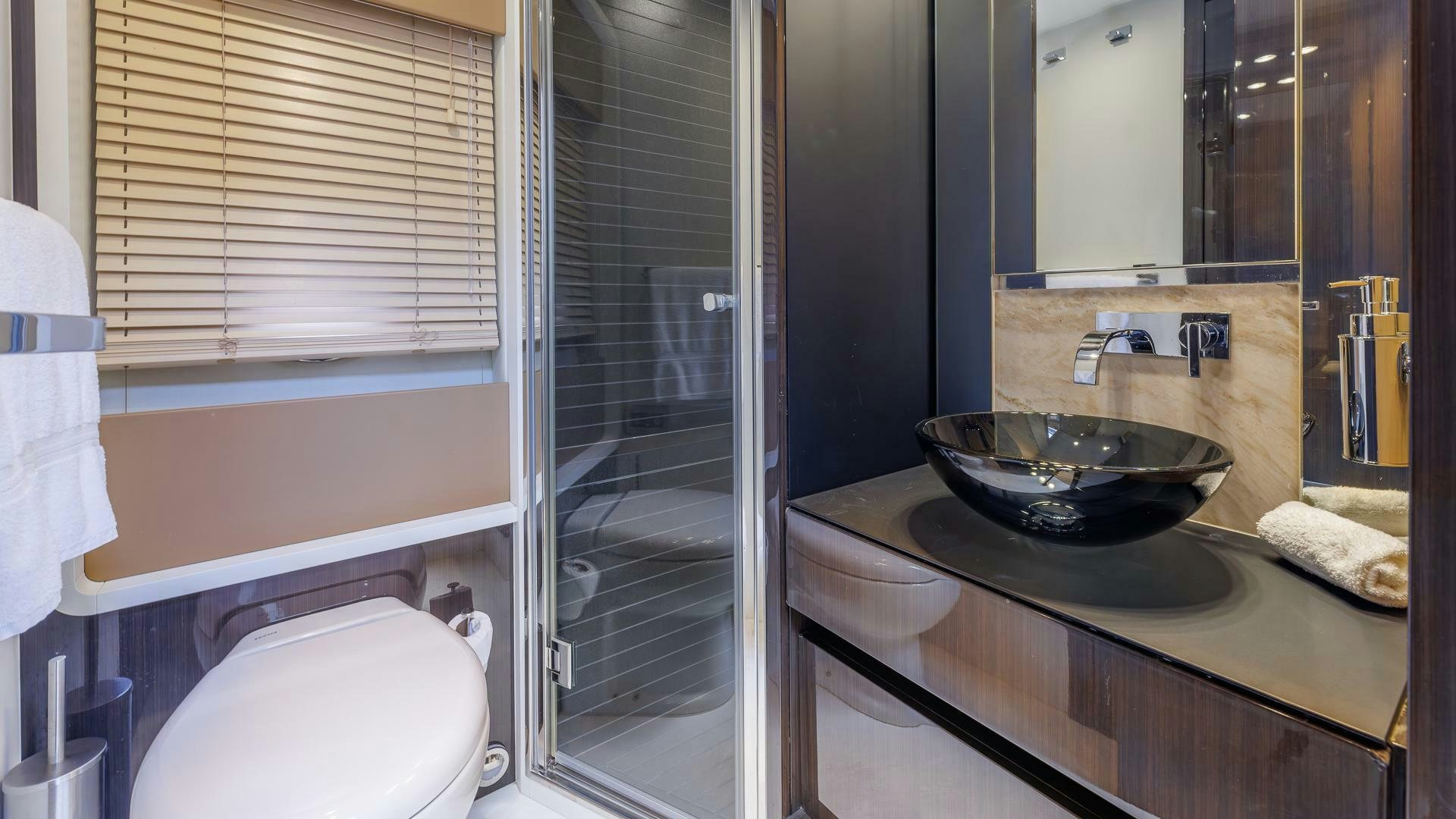 a bathroom with a sink and a toilet aboard DEVENZO Yacht for Sale