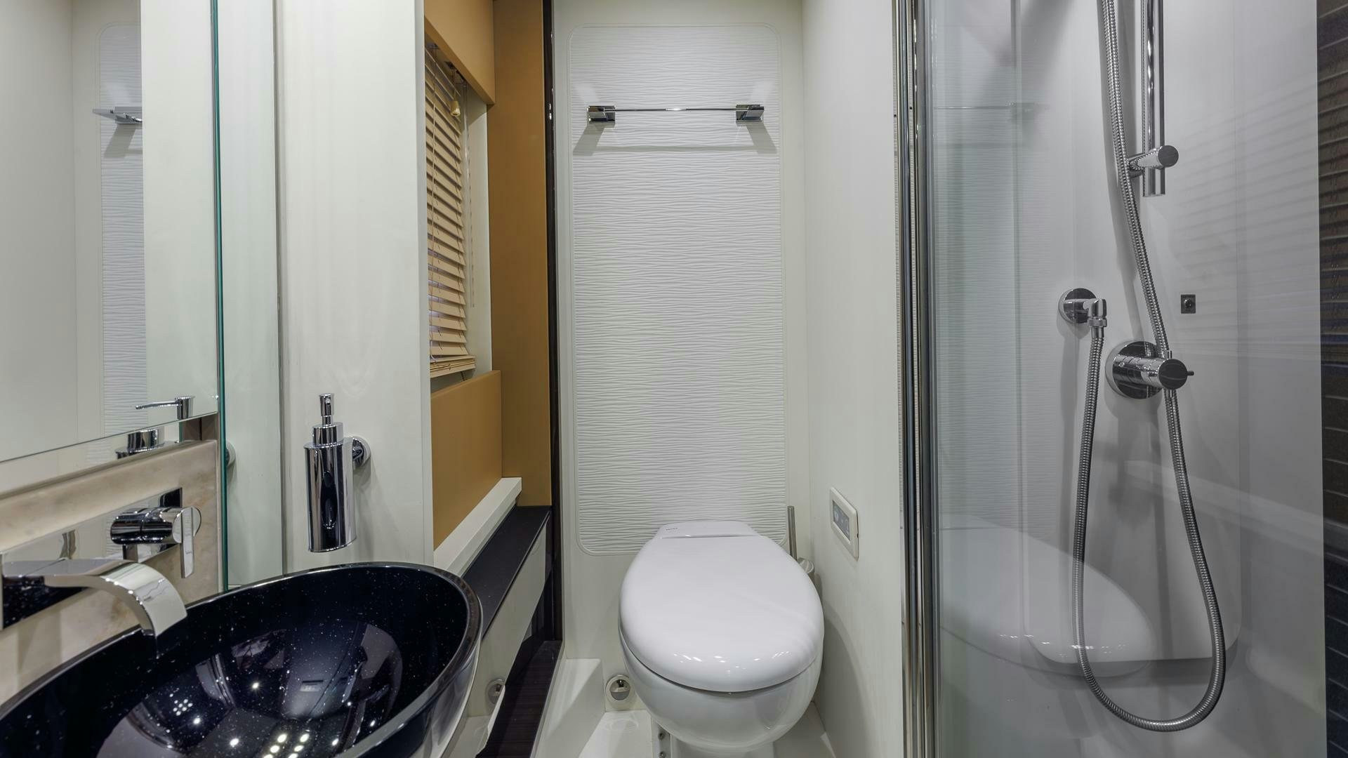 a bathroom with a sink toilet and a bathtub aboard DEVENZO Yacht for Sale