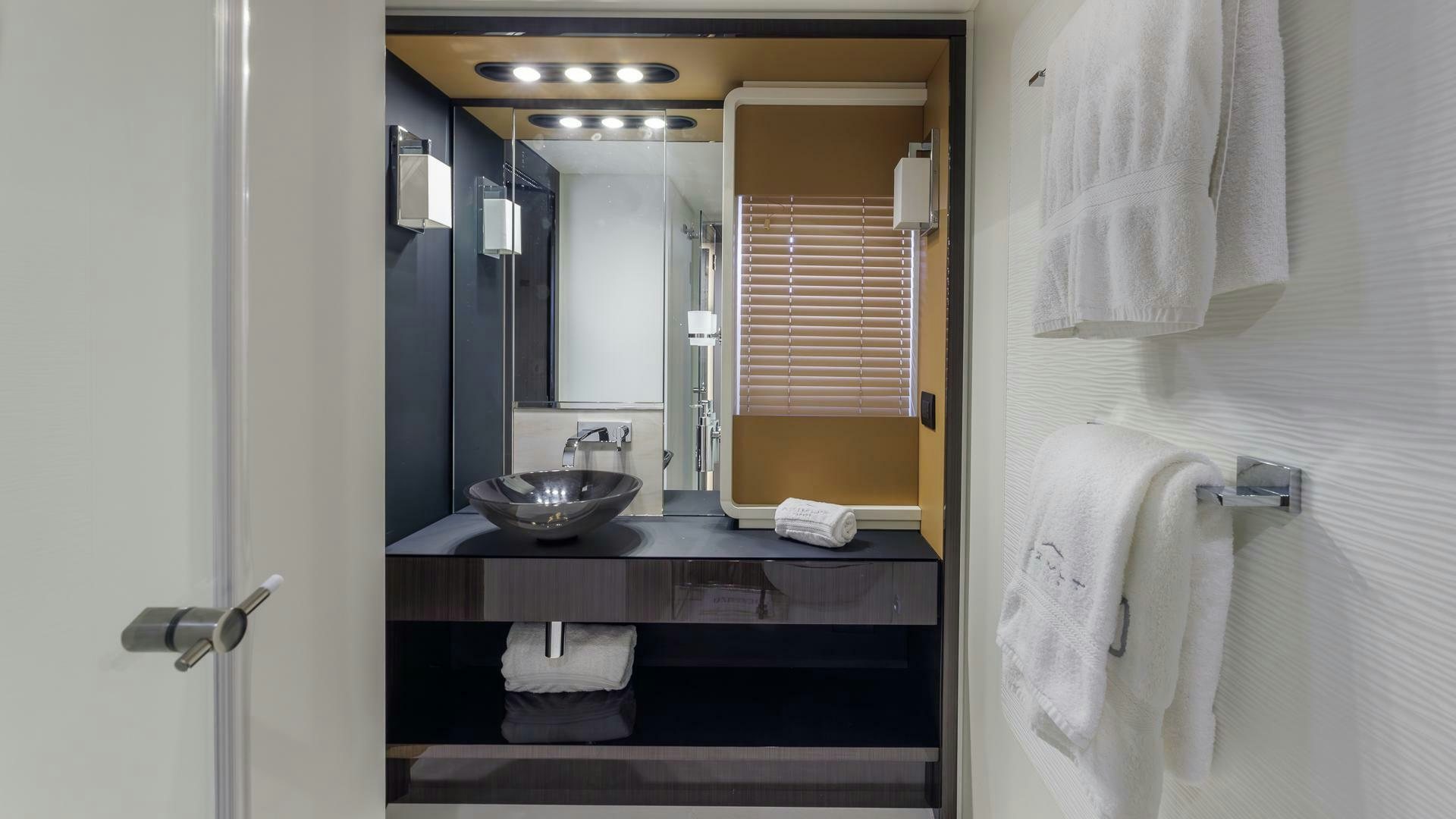 a bathroom with a sink and a mirror aboard DEVENZO Yacht for Sale