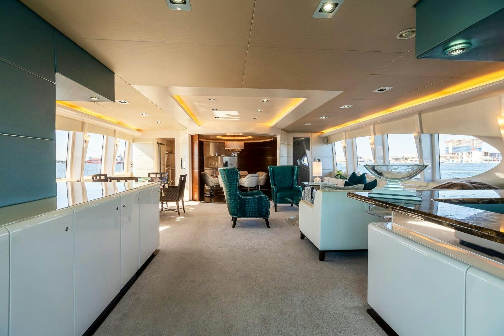 a room with a table chairs and a window aboard GRANDEUR Yacht for Sale