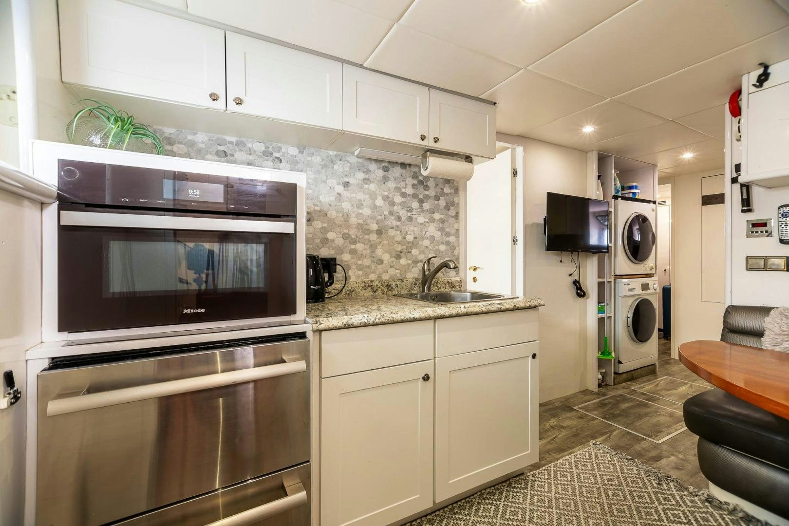a kitchen with white cabinets aboard GRANDEUR Yacht for Sale