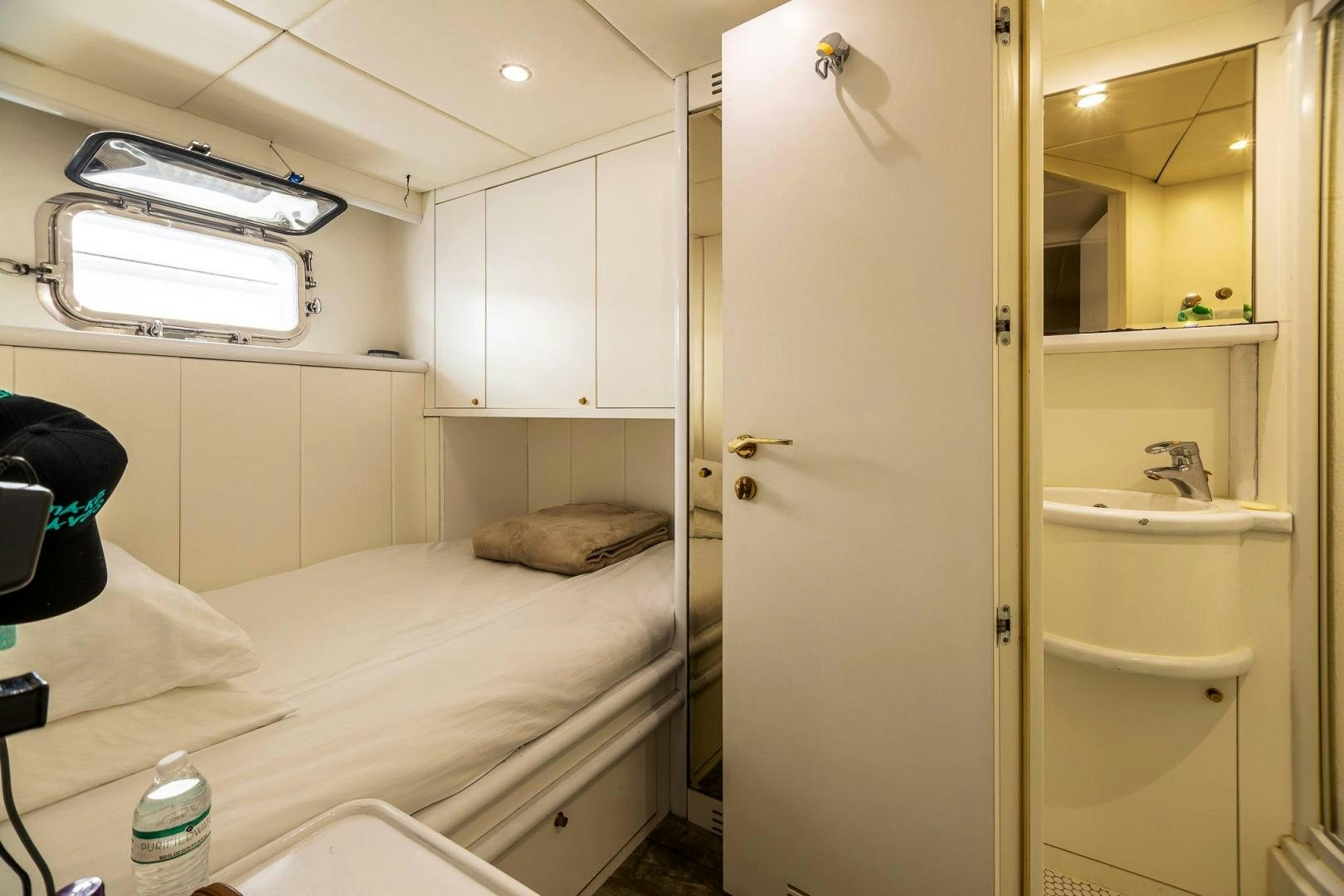 a room with a bed and a closet aboard GRANDEUR Yacht for Sale