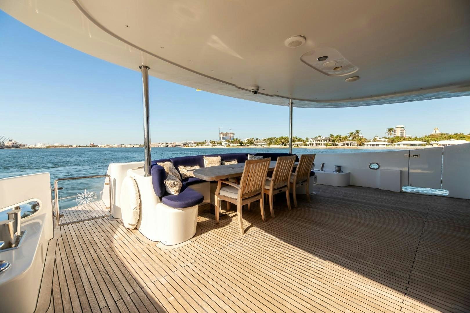 a large patio with a table and chairs on it aboard GRANDEUR Yacht for Sale