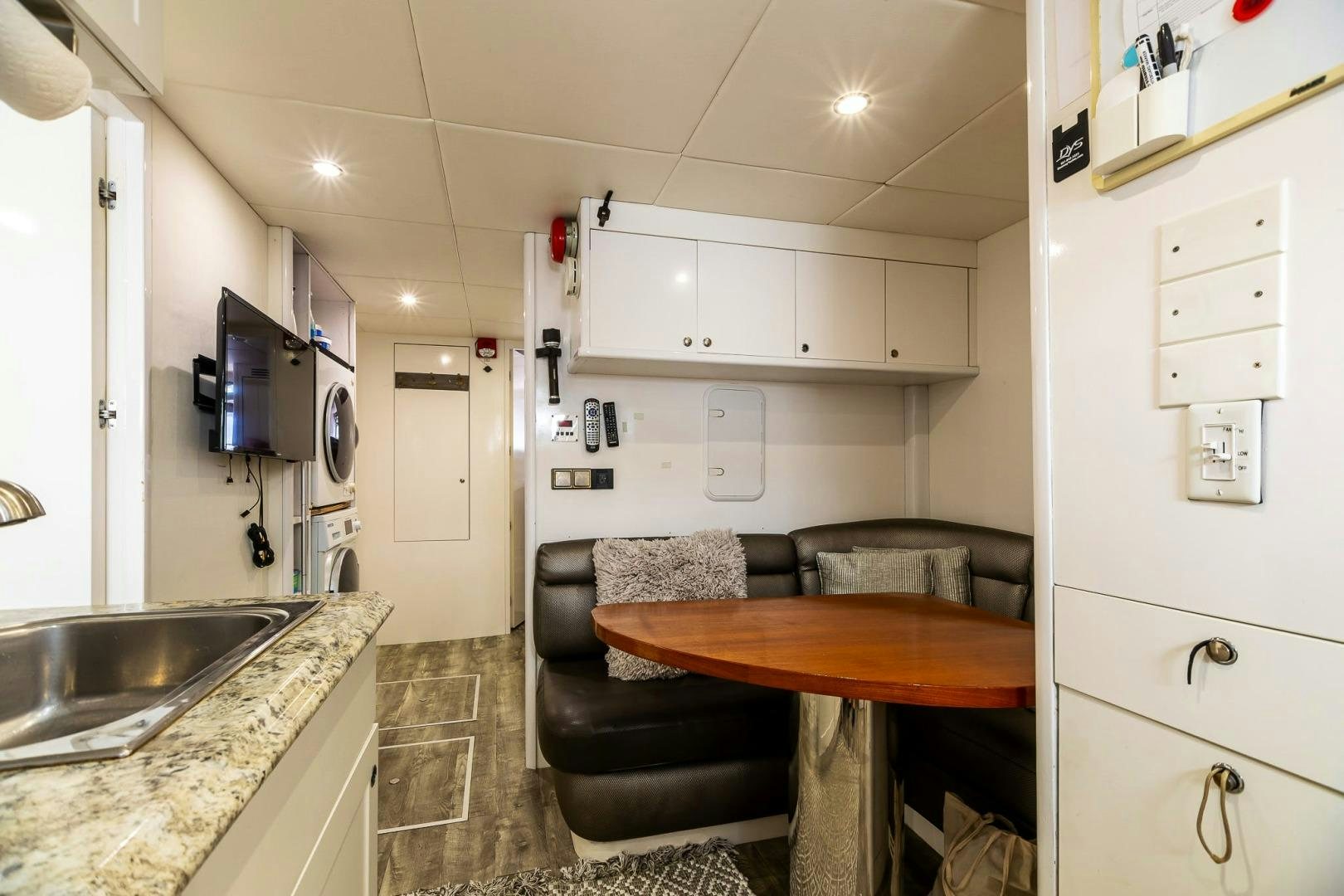 a kitchen with a table and chairs aboard GRANDEUR Yacht for Sale