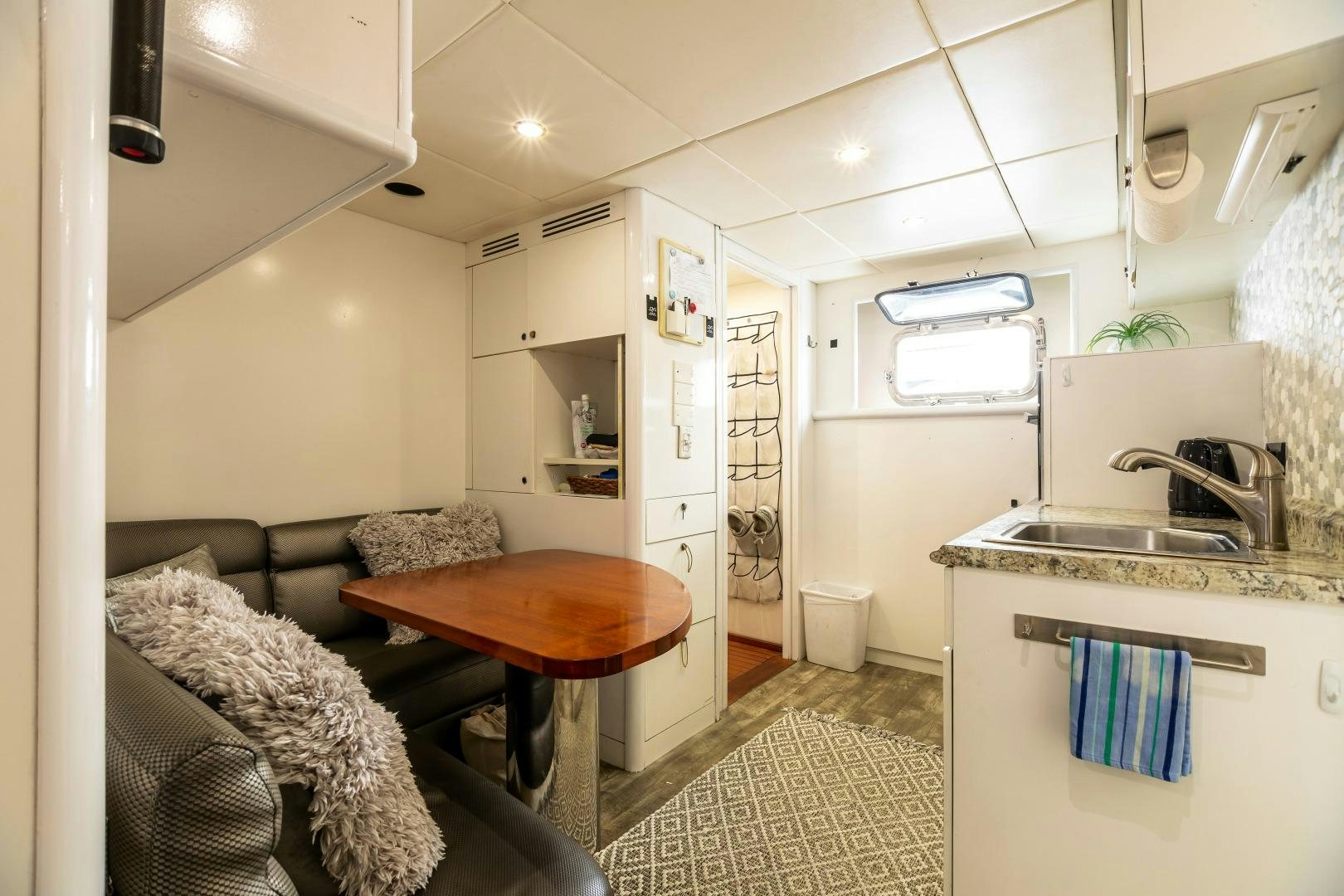 a small kitchen with a table aboard GRANDEUR Yacht for Sale
