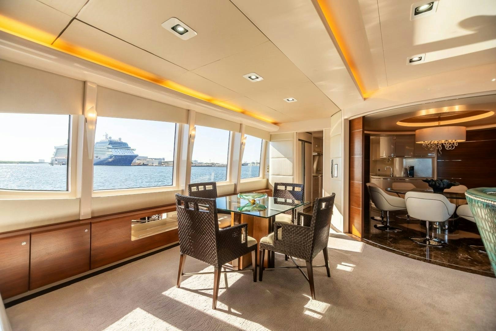 a room with a table and chairs aboard GRANDEUR Yacht for Sale