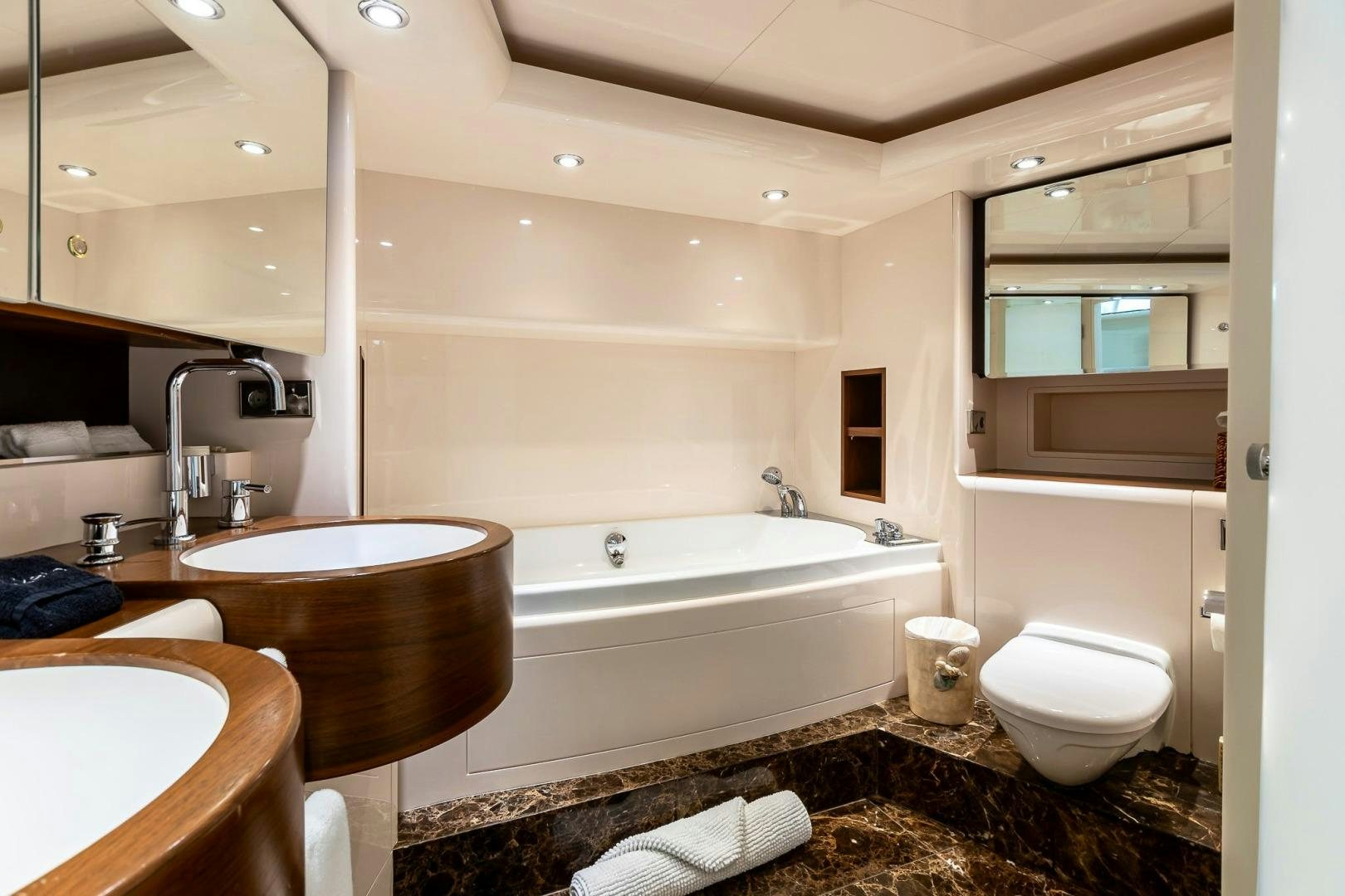 a bathroom with a tub sink and toilet aboard GRANDEUR Yacht for Sale