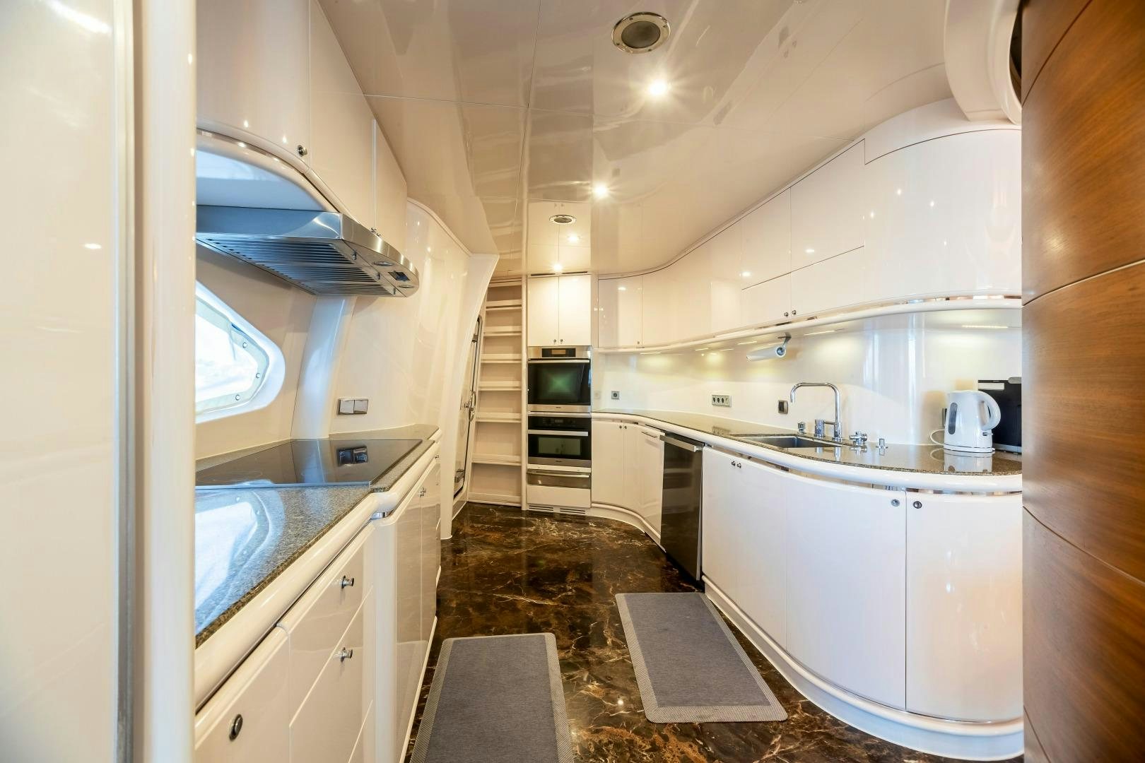a kitchen with a sink and a microwave aboard GRANDEUR Yacht for Sale