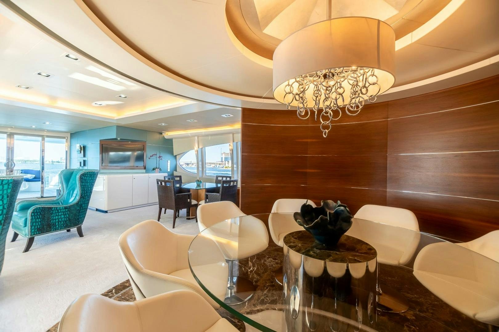 a room with a chandelier and chairs aboard GRANDEUR Yacht for Sale