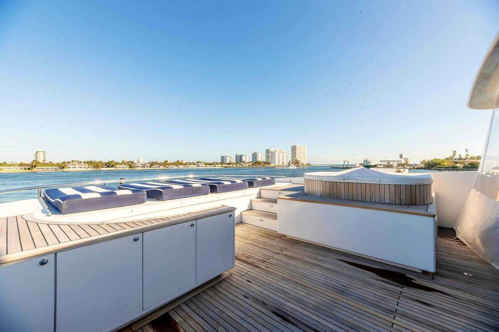 a deck with a view of a city and water aboard GRANDEUR Yacht for Sale