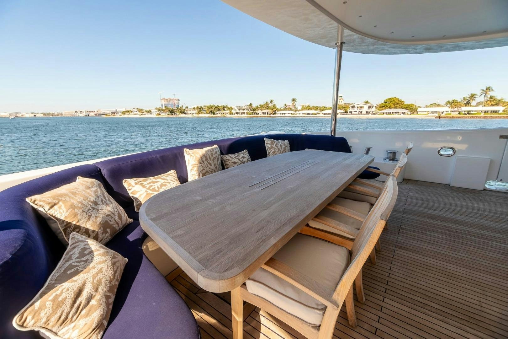a deck with pillows and a view of the water aboard GRANDEUR Yacht for Sale