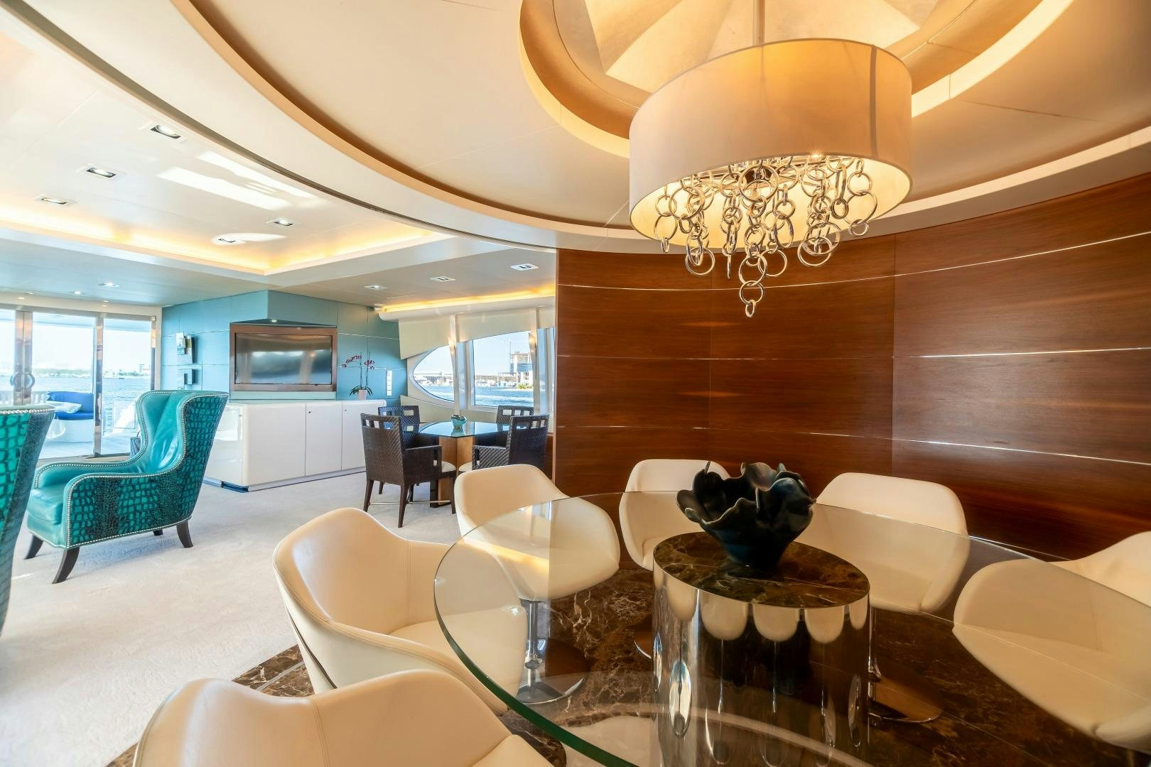 a room with a chandelier and chairs aboard GRANDEUR Yacht for Sale