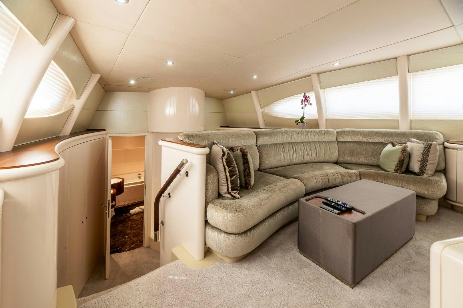 a living room with a couch and a coffee table aboard GRANDEUR Yacht for Sale
