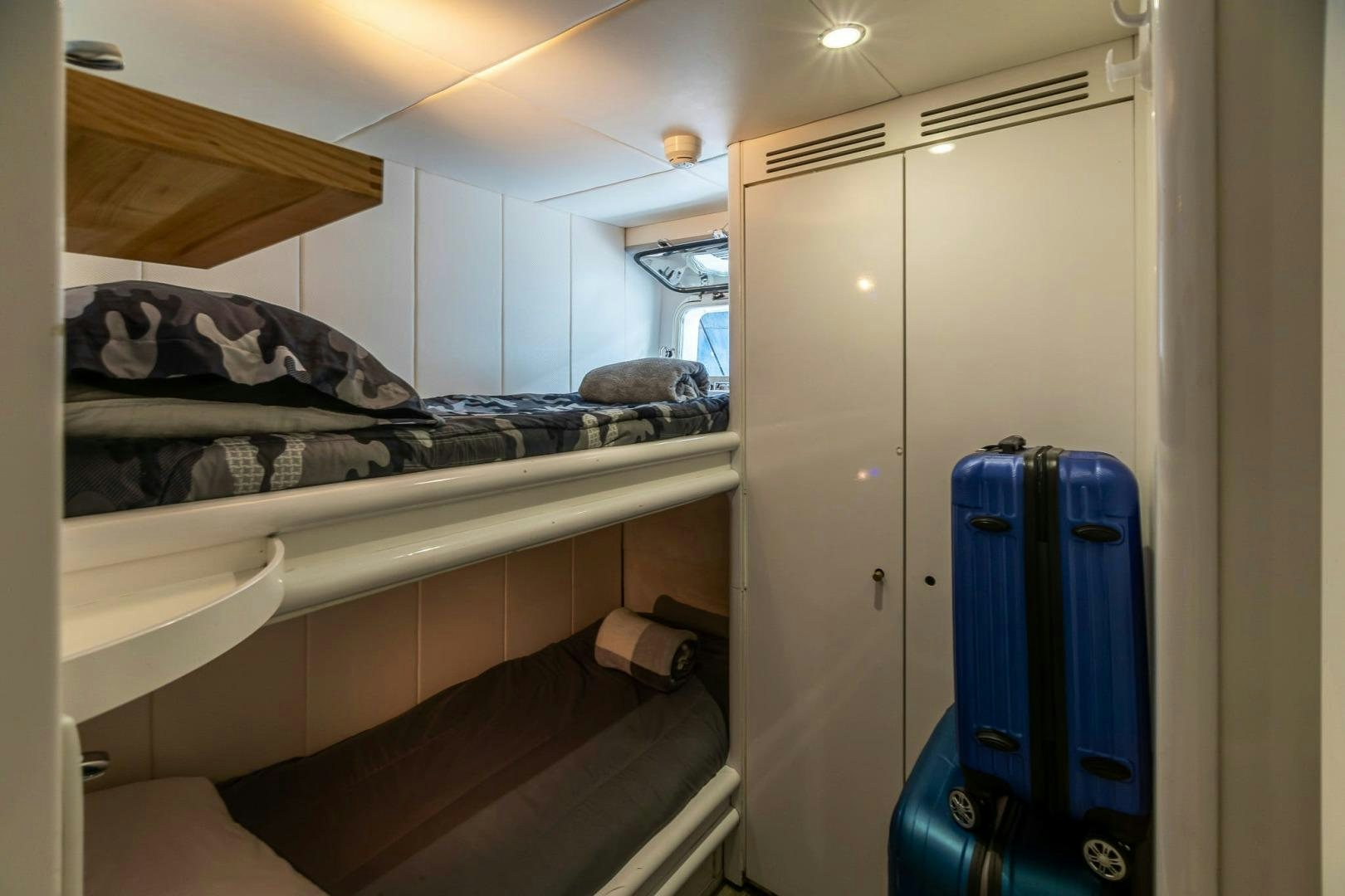 a small room with bunk beds aboard GRANDEUR Yacht for Sale