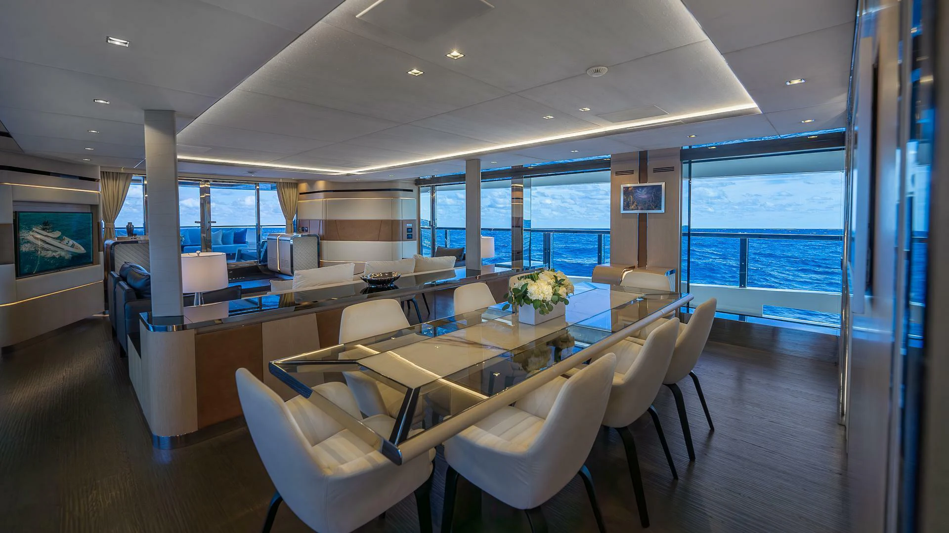 a room with a table chairs and a large window aboard NAMASTE Yacht for Sale